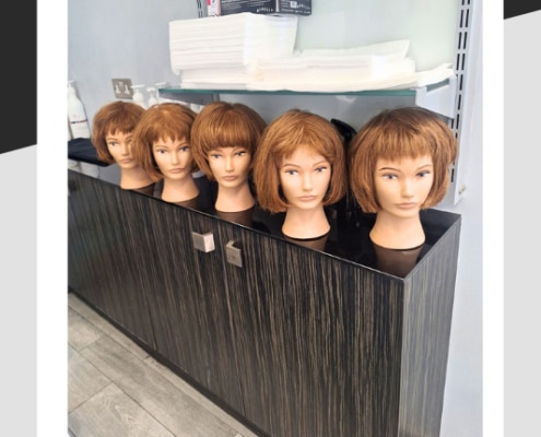 Row of five mannequin heads with different hair cuts