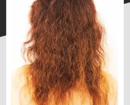Woman with long, dry brittle red hair.