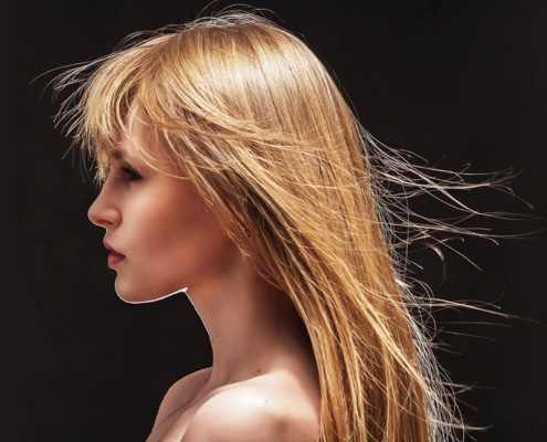 Woman with very wispy hair blowing everywhere